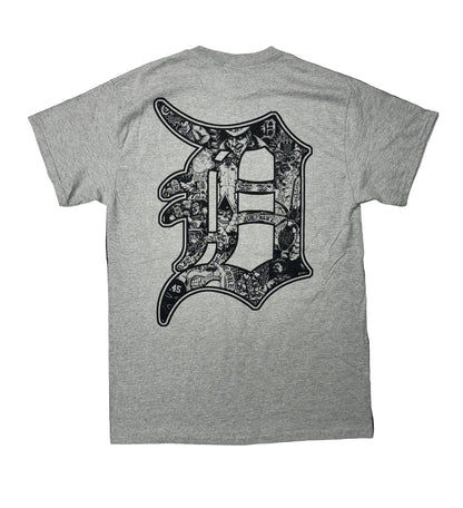 Gray t-shirt with a large black graphic on the back against a black background