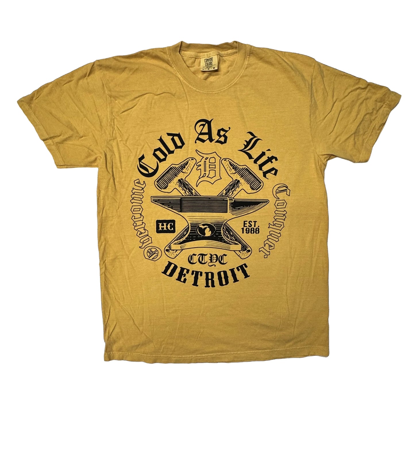 Beige t-shirt with black graphic design on a black background